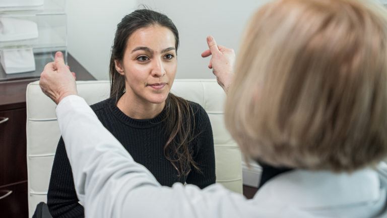 doctor performing a hearing test on her patient