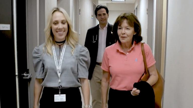 three people walking down a hallway