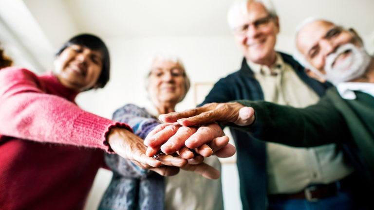 Seniors in a circle showing support