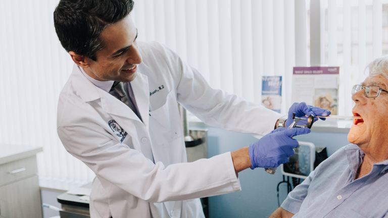 doctor examining his patient's mouth