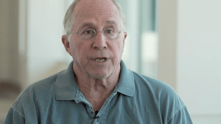 elderly man in a green shirt