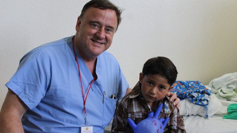 dr. chester griffiths with a young patient