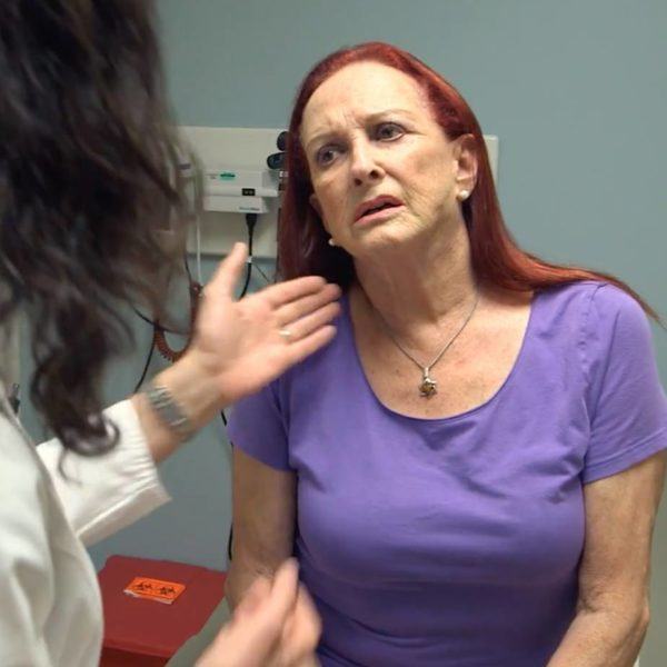 patient in a purple shirt speaking with her doctor