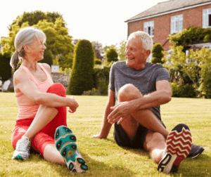Senior couple doing yoga outdoors