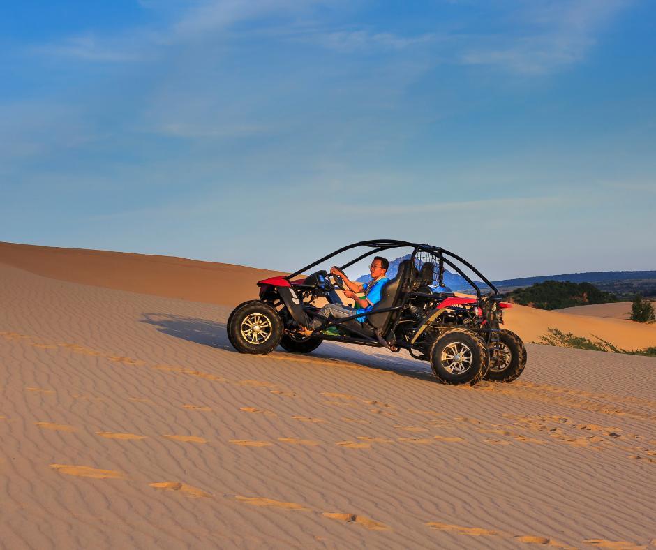 Man riding recreational utility terrain vehicle in the dessert