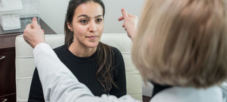 doctor performing a hearing test on her patient