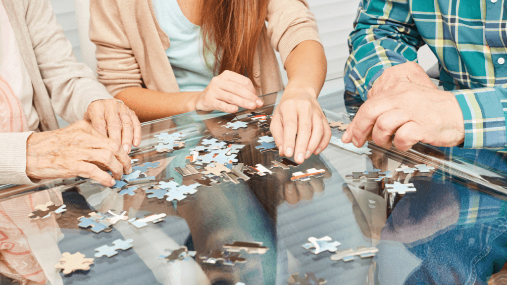 three people working on a puzzle