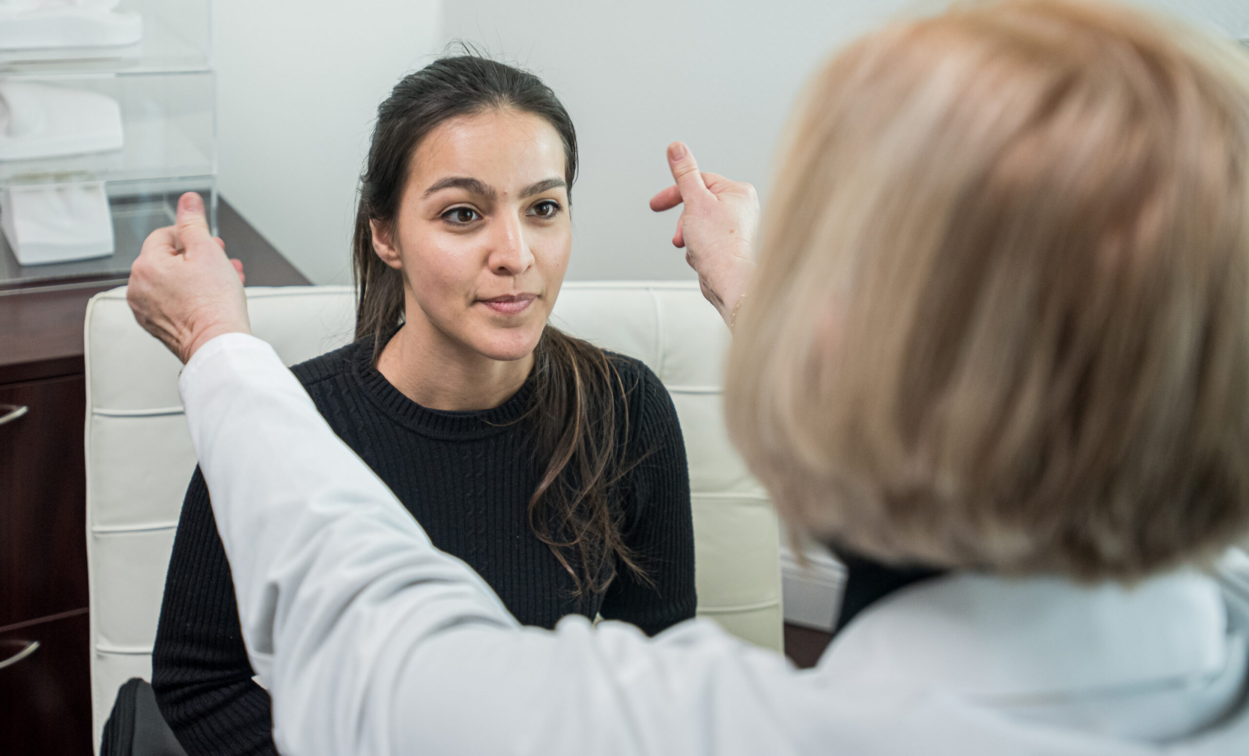 doctor performing a hearing test on her patient