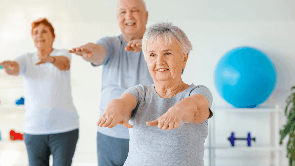 three elderly dementia patients exercising with hands outstretched in front of them