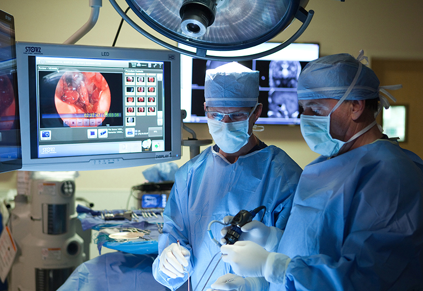 two doctors performing a surgery