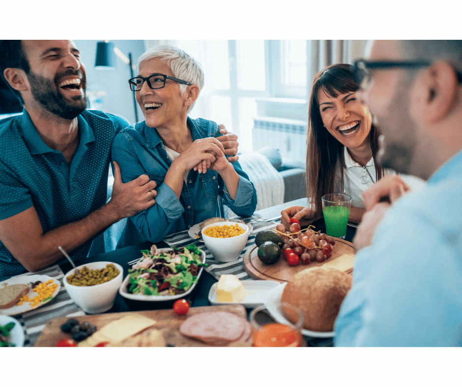 Senior family laughing at a table eating healthy food for lunch for National Nutrition Month