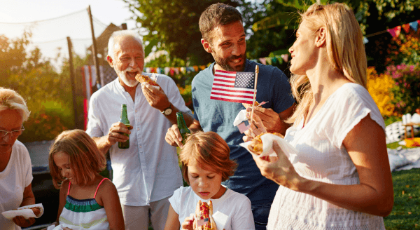 Family having a July 4th party in the yard.