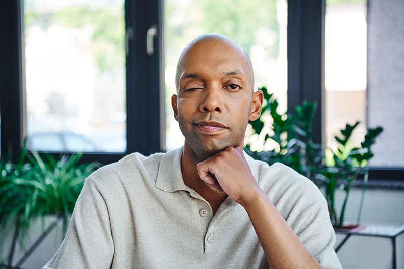 Man with muscle weakness due to Myasthenia Gravis causing his eyelid to droop.