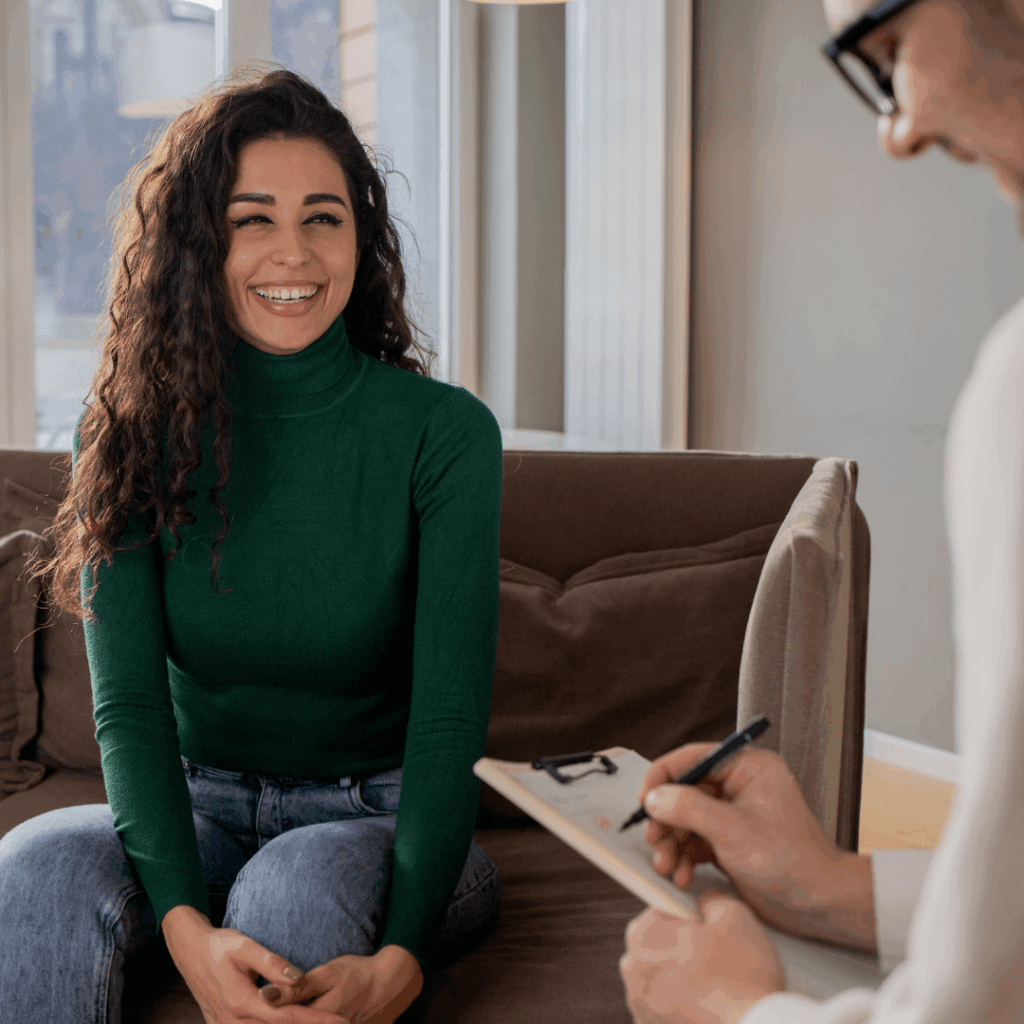 Young woman sitting in chair next to doctor