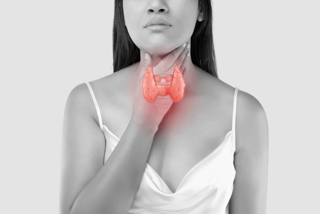 black and white image of women holding throat in pain 