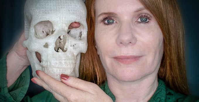 woman holding up a 3D printed skull