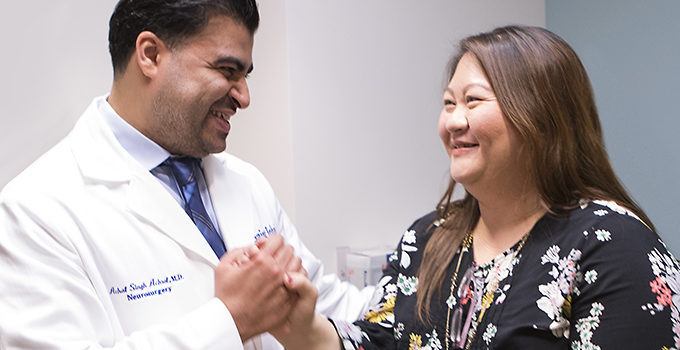 patient holding her doctor's hand