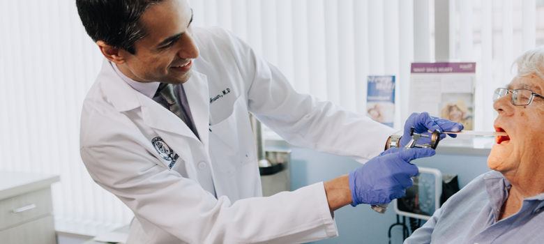 doctor examining his patient's mouth