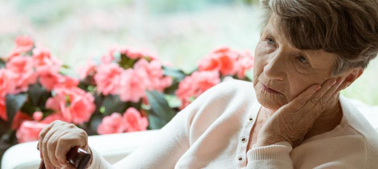 elderly patient sitting near flowers