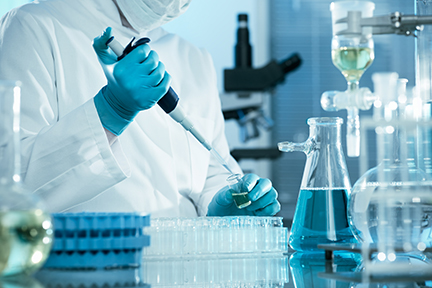 lab technician using a pipette