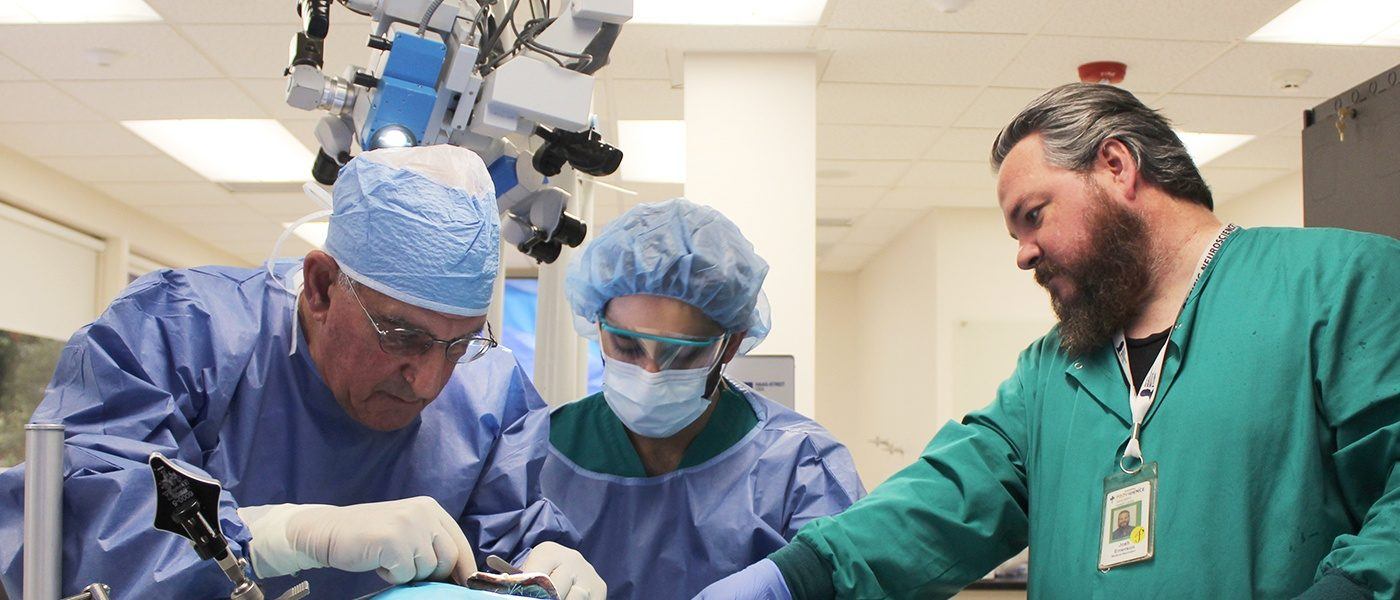 Three doctors performing a procedure