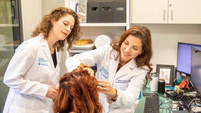 Dr. Lewis and Dr. Voelker examining Ayslyn at the Pacific Neuroscience Institute