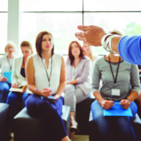 person presenting to a large group of females