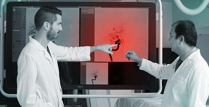 two doctors pointing at patient scans