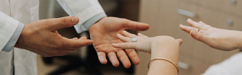 hands reaching out towards another set of hands