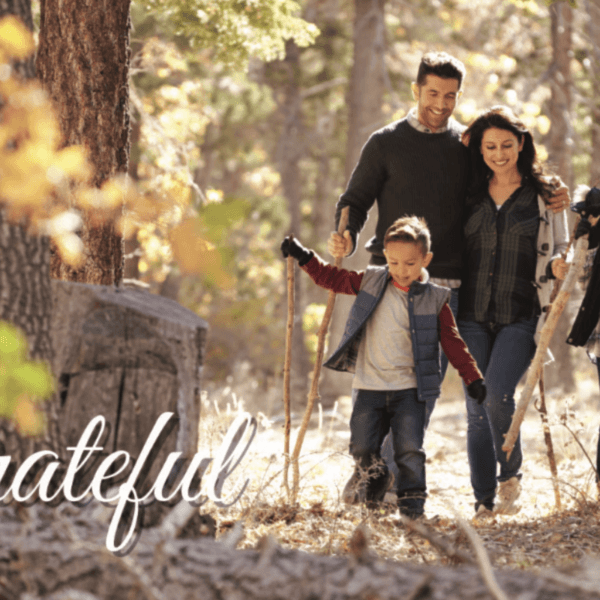 Family of four out on a hike with the word 'grateful' in the bottom corner