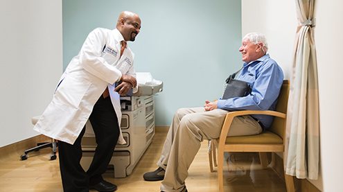 Dr. Santosh Kesari with a patient