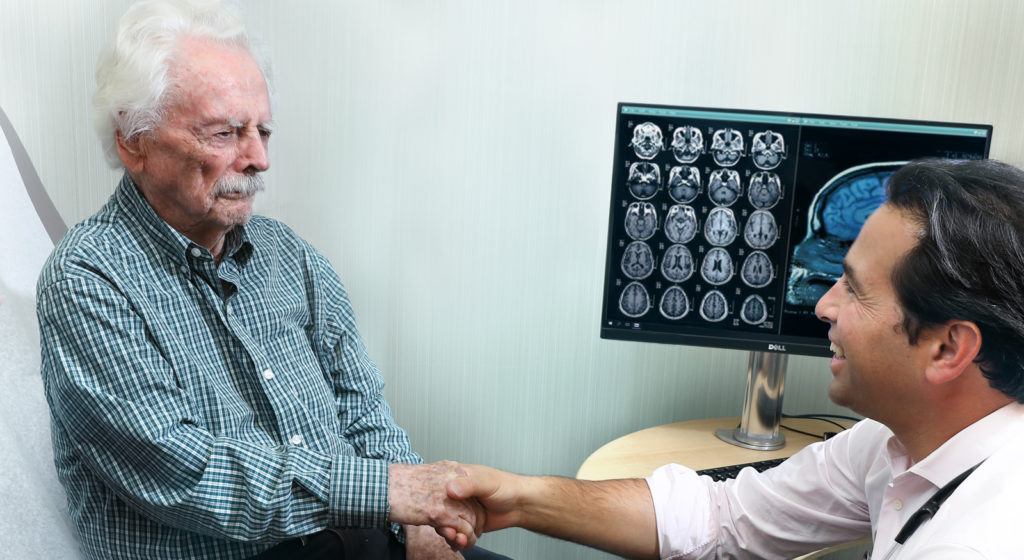 Doctor shaking hands with his elderly dementia patient