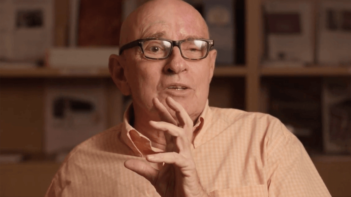 senior man in glasses and an orange shirt