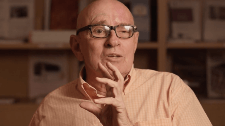 senior man in glasses and an orange shirt