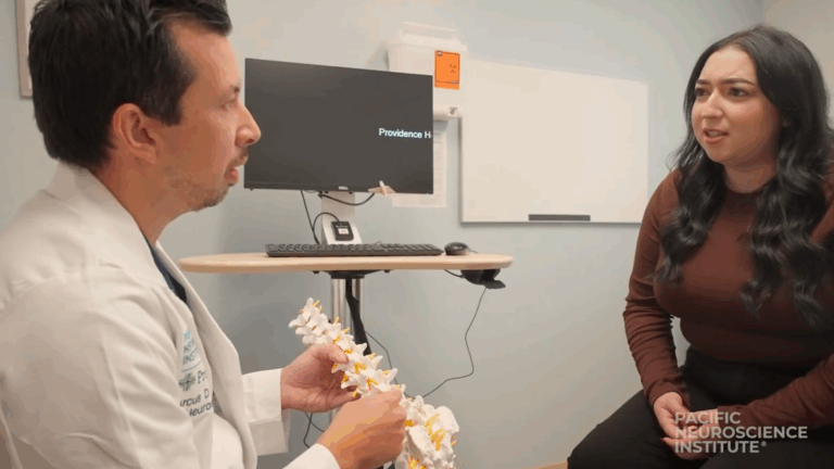 Marcus Mazur, MD discussing spine surgery with a patient