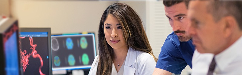 group of doctors viewing a computer screen