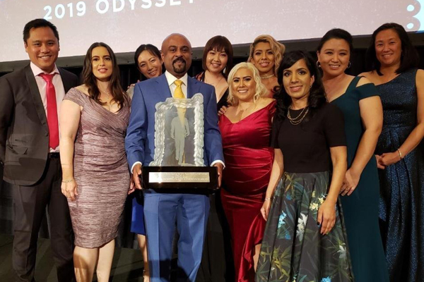 Dr. Santosh Kesari holding an award