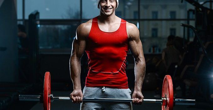 man lifting weights with santa hat