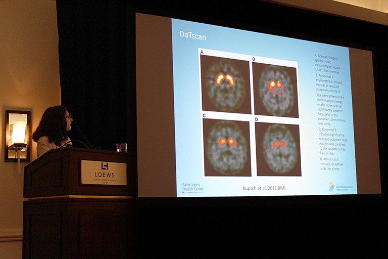 woman presenting at a conference