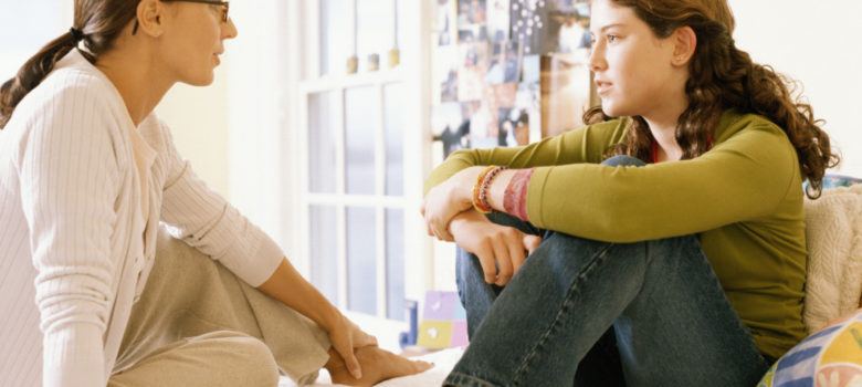 mother speaking with her teen daughter