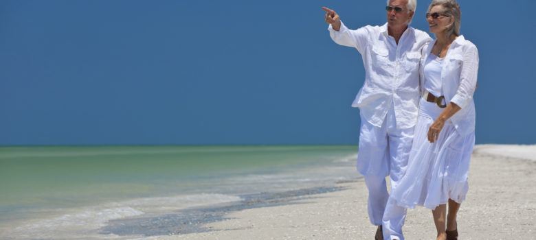 senior couple walking on a beach