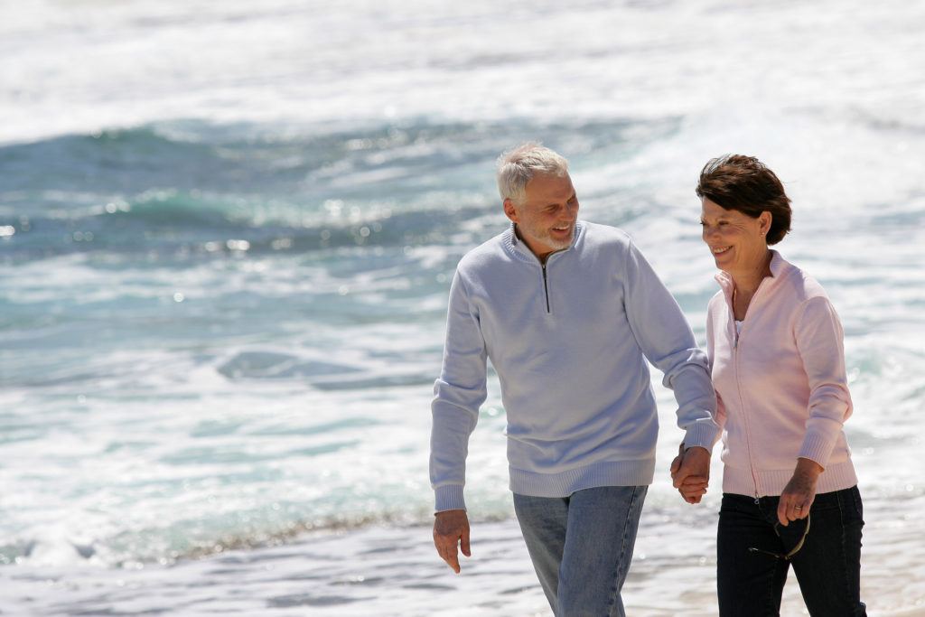 Couple walking along the shore